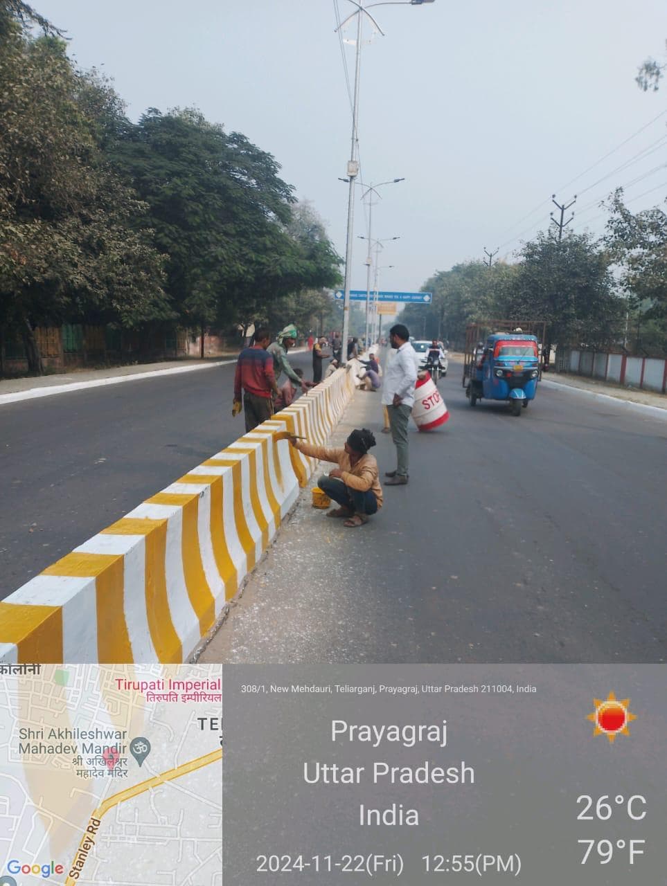 Workers painting road dividers